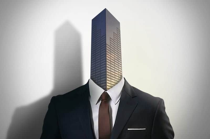 Corporate building rising out of a corporate suit