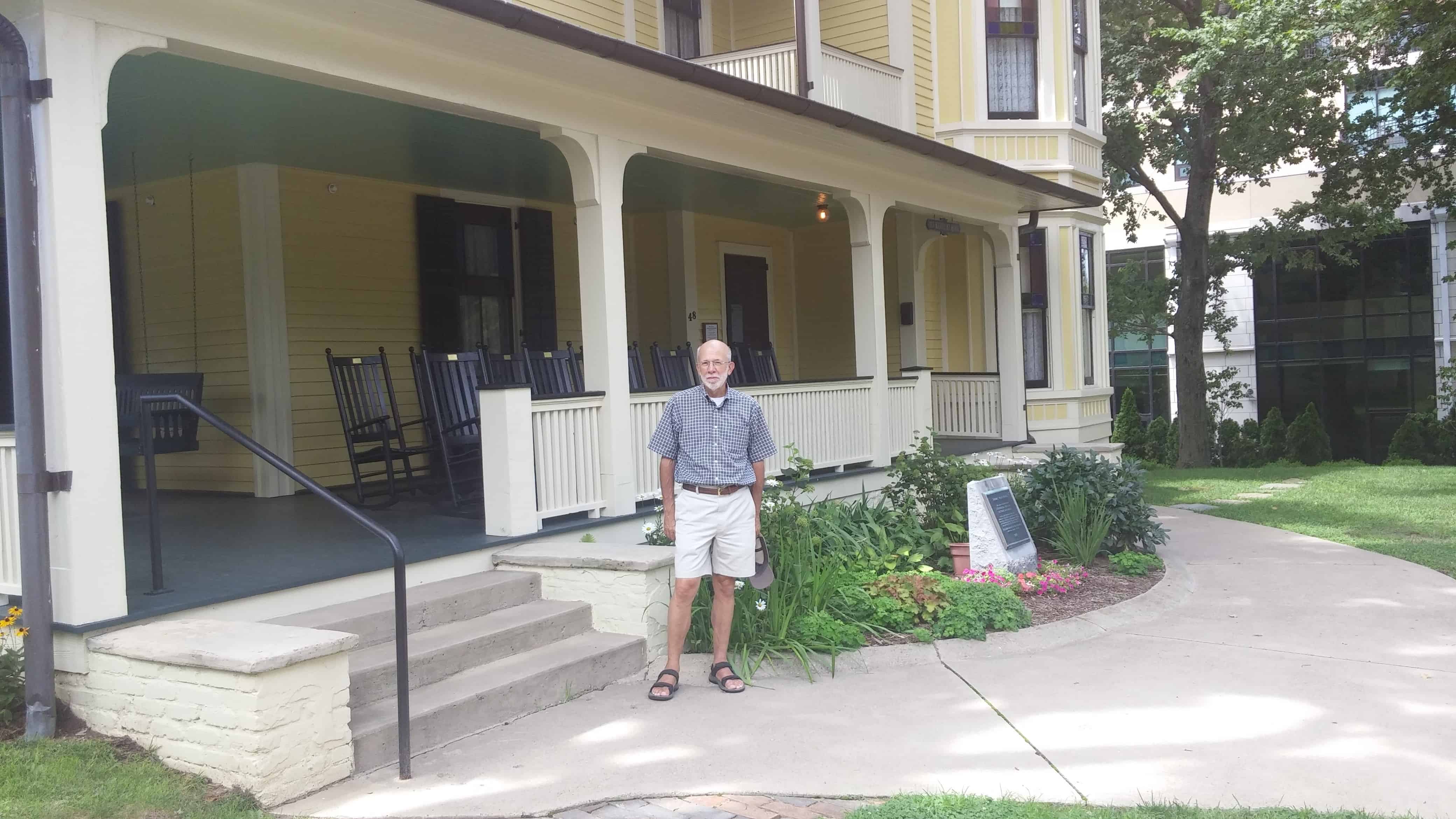 Standing in front of Tom Wolfe's Asheville porch with rocking chairs dedicated to southern writers