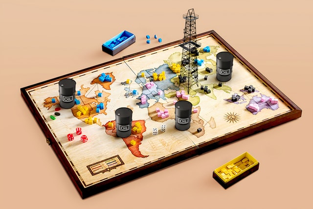 Game board with world map and oil derrick and barrels